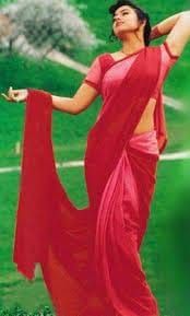 a woman in a red sari is holding her arms out to the side and looking up