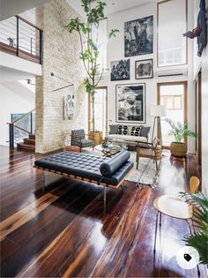 a living room filled with furniture and pictures on the wall above it's fireplace