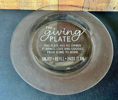 a glass plate with an inscription on it that says, the giving plate this plate has no owner it brings love and goodies from home to home