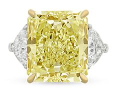 This monumental 20.28-carat natural fancy yellow diamond ranks among the rarest and most coveted of all gemstones. The rare stone is certified by the Gemological Institute of America (GIA) as natural fancy yellow, and its exceptional hue displays even color distribution that is enhanced by its modified brilliant cut. It also earns a VVS2 clarity grade, meaning its natural color is virtually unmarred to the naked eye - a rare achievement for a stone of this size. Colored diamonds are among the sc Rare Diamond Rings, Rings Fancy, Glitter Rocks, Fancy Yellow Diamond Ring, Radiant Cut Diamond Ring, White Engagement Ring, Jewelry Fancy, Yellow Diamond Ring, Canary Diamond