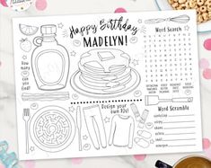 a happy birthday madelyn recipe card on top of a table with coffee and snacks