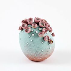 a blue vase with pink flowers in it