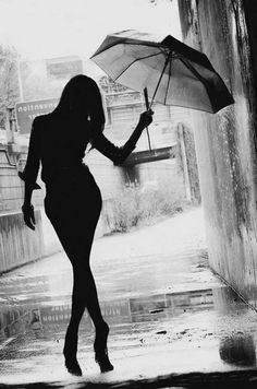 a woman holding an umbrella in the rain