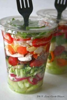 two plastic cups filled with different types of salad