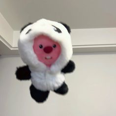 a stuffed panda bear hanging from the ceiling