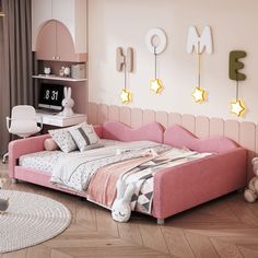 a bedroom with pink furniture and decorations on the wall