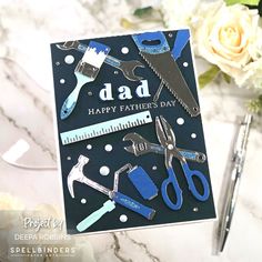 a father's day card with scissors and tools on it, next to flowers