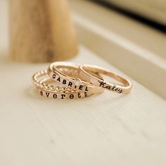 Mother's Day Gift | Personalized stackable ring set, engraved with a name, date, or special word.  Metal: 14k gold filled or fine/sterling silver Dimensions: 2mm tall on average, but our rings are handmade so variations will occur. The birthstone is 2mm on a 1mm band, and the beaded ring is 2 mm. Font: lowercase cursive, uppercase bold block, and lowercase typewriter Unsure what size you need? We highly recommend using our ring sizer for an accurate fit. Some people find that sizing up when stac Adjustable Personalized Yellow Gold Midi Rings, Adjustable Personalized Gold Stackable Rings, Mother's Day Adjustable Stackable Rings With Custom Name, Adjustable Stackable Rings With Custom Name For Mother's Day, Personalized Adjustable 14k Gold Stackable Rings, Personalized Adjustable 14k Gold Midi Rings, Personalized Adjustable Stackable 14k Gold Rings, Mother's Day 14k Gold Stackable Rings, Custom Name Stackable Rose Gold Promise Rings