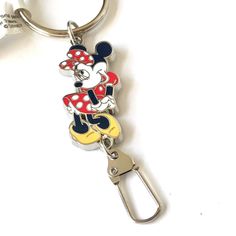 a mickey mouse keychain is shown on a white surface