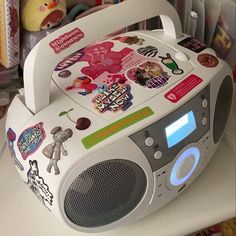 an electronic device with many stickers on it's side sitting on a table