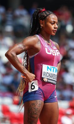 a female athlete with her hands on her hips