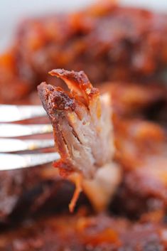 a close up of a fork with food on it