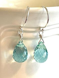 Gorgeous faceted green amethyst quartz teardrops wire wrapped in sterling silver.  Lush pale seafoam green briolettes measure 12-13mm. Color is slightly more intense than green amethyst.  Gems hang from classic .925 sterling silver French hooks. Total drop is 1 1/4 in. Also in 14k gold fill.  February birthstone earrings. Faceted Teardrop Earrings As Gift, Faceted Teardrop Earrings For Jewelry Making, Wire Wrapped Teardrop Drop Earrings, Faceted Teardrop Earrings For Gifts, Faceted Drop Teardrop Earrings For Gift, Handmade Green Teardrop Crystal Earrings, Aquamarine Drop Earrings With Ear Wire, Faceted Briolette Teardrop Earrings, Handmade Aquamarine Drop Earrings