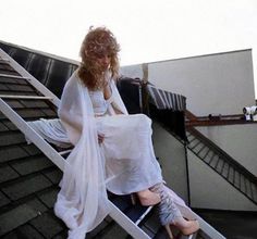 a woman sitting on top of a set of stairs