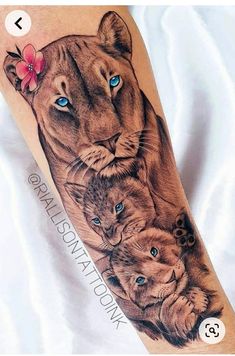 a woman's arm with a lion and cubs tattoo on it