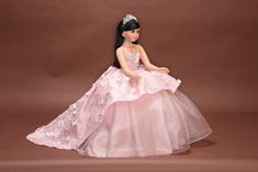 "Make it extra special by purchasing the arch gift wrapping Looking for something extraordinary for that upcoming special occasion? This gorgeous Quinceanera gift doll is perfect for that special day. Doll features an elegant dress. Vinyl quinceanera doll available in 24\" and 30\". Porcelain doll only available in 22\". Dress features a beautiful design. This doll has a full body with legs. Includes a standing base and mini tiara. Doll has beautiful long hair accented with a mini tiara. This qu Quince Doll, Royal Blue Quinceanera, Quinceanera Gifts, Sweet Fifteen, Pretty Quinceanera Dresses, Quinceanera Party, Doll Crochet, Beautiful Long Hair, May 23