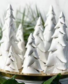 small white christmas trees on a gold platter