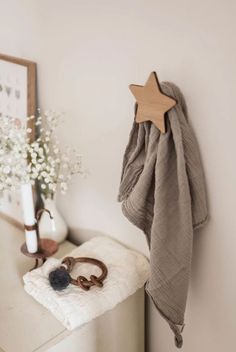 a wooden star hanging on the wall next to a pair of scissors and other items