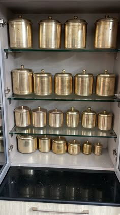 the shelves are filled with pots and pans