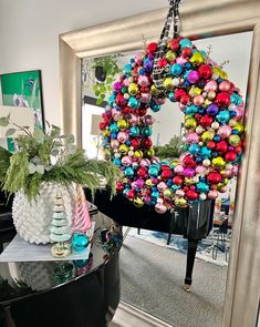 a wreath is hanging on the wall next to a piano