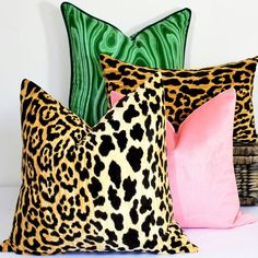 three different colored pillows sitting next to each other