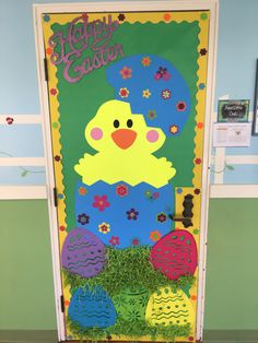 a door decorated with easter eggs and an image of a chick