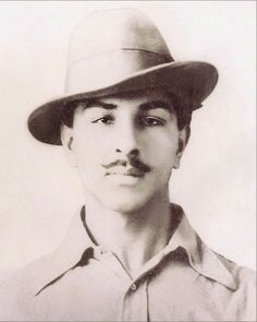 an old black and white photo of a man with a mustache wearing a fedora