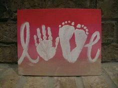 a red and white painting with the word love painted on it