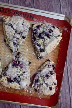 blueberry scones are on a baking sheet ready to be baked in the oven