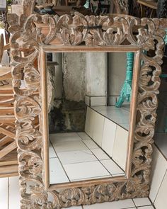 a mirror sitting on top of a tiled floor