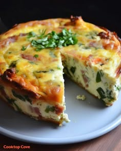 a quiche on a plate with one slice missing