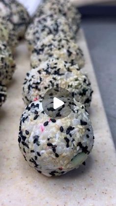 there are several donuts with black and white sprinkles on the top