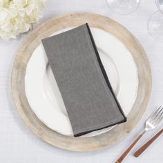 a place setting with silverware and napkins