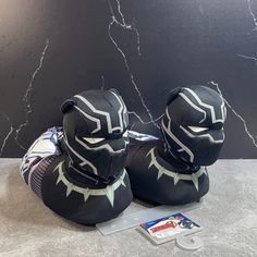 pair of black panther hat and booties sitting on top of a marble countertop