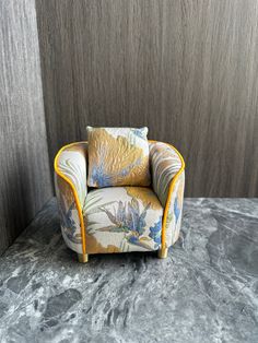 a chair sitting on top of a marble floor next to a wooden paneled wall