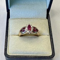 This Listing Is For A Fantastic Ring Crafted Of Solid 14k Yellow Gold And Featuring A Marquise Cut Ruby Surrounded By 12 Round Cut Diamonds. Includes A Total Of 6 (3 On Each Side) Marquise Cut Rubies Counter Sunk Into The Side Shank As Shown In The Photos. The Top Ruby Measures Approximately 7 X 4 Mm. Crafted Of Solid 14k Yellow Gold The Total Weight Is Approximately 4.48 Grams. Hallmarked On The Inside Of The Band "Lgl 14k". Rubies Are The Birthstone For July. Currently A Size 8 But Can Be Resi Vintage Marquise Ruby Ring As Gift, Luxury Marquise Cut Ruby Ring For Gift, Luxury Marquise Ruby Ring Gift, Marquise Cut Ruby Jewelry In Yellow Gold, Gold Marquise-cut Ruby Jewelry, Ruby And Diamond Ring, Ring Crafts, Marquise Cut, Round Cut Diamond