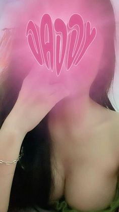 a woman is holding up her face with the word love spelled in pink on it