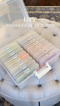 a plastic storage box filled with toddler's toy boxes on top of a chair