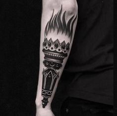 a man's arm with a black and white tattoo on it