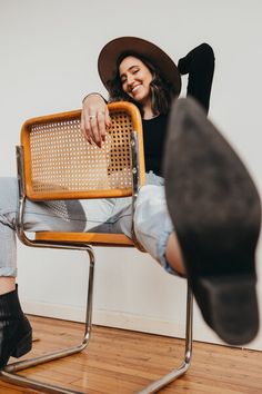 a woman sitting in a chair with her feet up