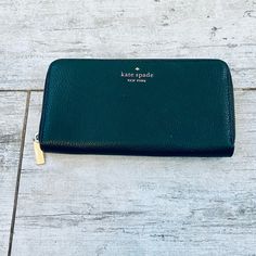 Kate Spade Deep Evergreen Pebble Leather Large Continental Wallet New Never Used No Blemishes No Stains Staci Collection Color Is Deep Evergreen (961) Ivy Green Pebble Leather Large Wallet With Zip Closure 12 Credit Card Slots 2 Interior Slip Pockets 3 Billfold Interior Pockets Green Spade Logo Fabric Interior Interior Zip Pocket Back Exterior Slip Pocket Gold Pin Mounted Spade Logo Gold Hardware Measurements 3.9" H X 7.6" W Tag And Care Card Included Happy Poshing! Green Leather Wallet With Zipper Closure, Green Leather Wallets With Zipper Closure, Elegant Green Wallets With Card Slots, Classic Green Wallet For Daily Use, Elegant Green Wallets For Travel, Formal Green Bags With Card Slots, Elegant Green Bifold Wallet, Green Leather Travel Wallet, Kate Spade Wallet Pink