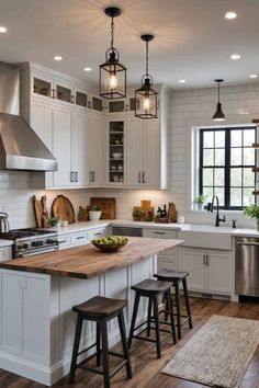 a large kitchen with white cabinets and wooden counter tops, along with two stools that match the hardwood flooring