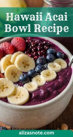 a bowl filled with blueberries, bananas and raspberries on top of a wooden table