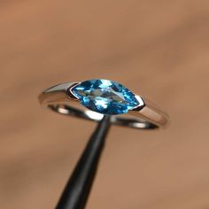 It is a Swiss blue topaz ring. The main stone is 5 mm* 10 mm marquise cut.weight about 1.24 carats.The basic metal is sterling silver and plated with rhodium.To change the metal to a solid gold (white/rose) or platinum is also available, please ask for a quotation if you want.You can also go to my shop Home for more elegant rings: https://www.etsy.com/shop/godjewelry?ref=hdr_shop_menu Swiss blue topaz is November birthstone More Swiss blue topaz rings:https://www.etsy.com/shop/godjewelry?ref=sel Rainbow Topaz Ring, Blue Aquamarine Ring, March Birthstone Ring, Swiss Blue Topaz Ring, Mystic Topaz Ring, Liberty Blue, Ring Marquise, Aquamarine Engagement Ring, London Blue Topaz Ring