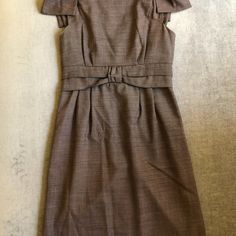 Beautiful, Sleek, Classy, Very Flattering Brown Wool Dress. Shoulder Bows. Exposed Back Zipper With Ribbon Pull. Knee Length. Scoop Neckline In Front, V-Neckline In Back. Pleated Waist With Center Knot. Fully Lined. Body Corps: 97% Wool 3% Lycra Lining: 100% Polyester Dry Clean Only Rn# 103927 Ca#: 40634 The Mannequin Photos I Included Are From An Identical Listing To Mine-- They Are Not My Photos, But It Is The Exact Same Size And Dress. It Shows The Fitted Waist, Which I Thought Is Important Fitted Brown Mini Dress With Button Closure, Brown Ruched Knee-length Mini Dress, Brown Fitted Button-up Mini Dress, Brown Knee-length Mini Dress With Button Closure, Marc Jacobs Dress, Wool Dress, Dress With Bow, Size 2, Scoop Neckline