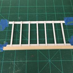 the bottom part of a dollhouse bed frame is cut out and ready to be assembled