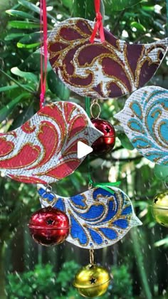 christmas ornaments hanging from a tree in the rain