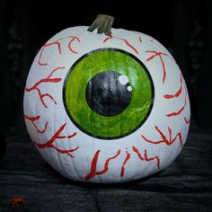 a painted pumpkin with an eyeball on it