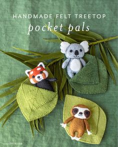 handmade felt tree top pocket pals with two stuffed animals on them and leaves