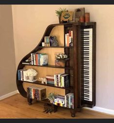 a piano shelf filled with books on top of a hard wood floor